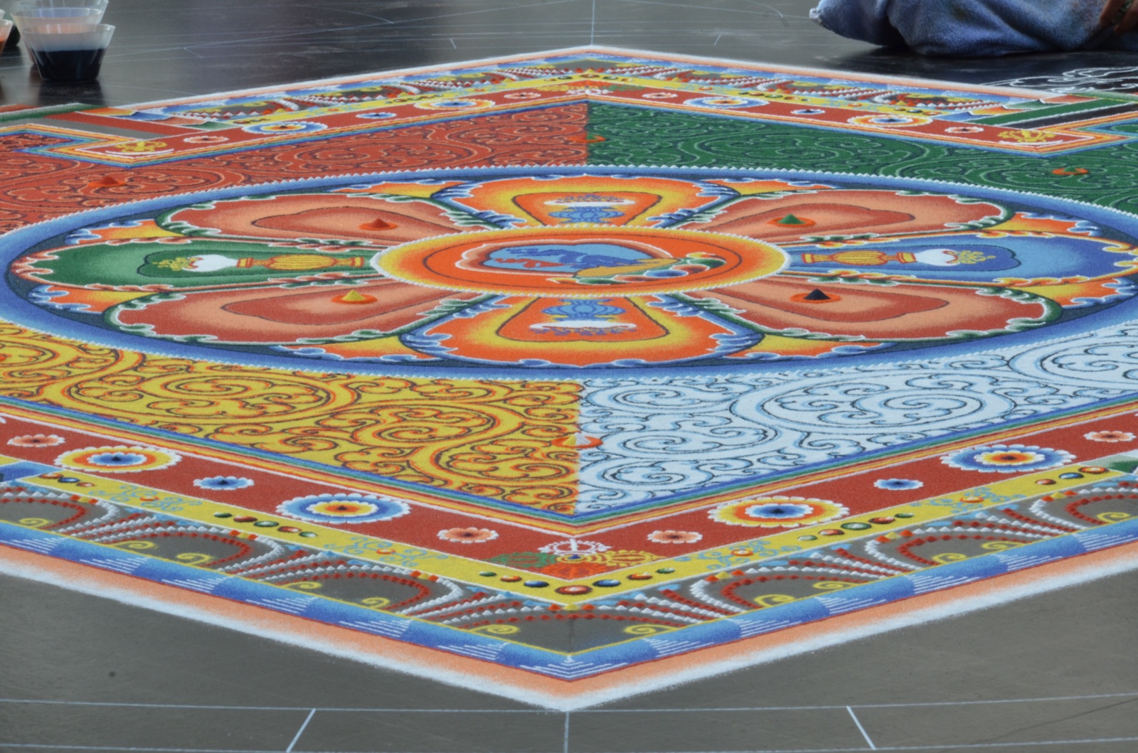 Tibetan monks finish a sand mandala that they will dismantle in hours. The point is the act, not the keeping.
